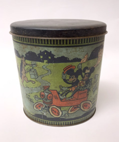 Illustrated oval canister or biscuit tin with a dark coloured lid. It  features a coloured depiction of Mickey Mouse and Minnie Mouse riding in a car with a "Just Married" sign hanging from the rear of the car. Mickey drives the car.  A variety of animal singers and instrument players are sending them off on their way in a jovial way. A kangaroo as part of the musical ensemble.