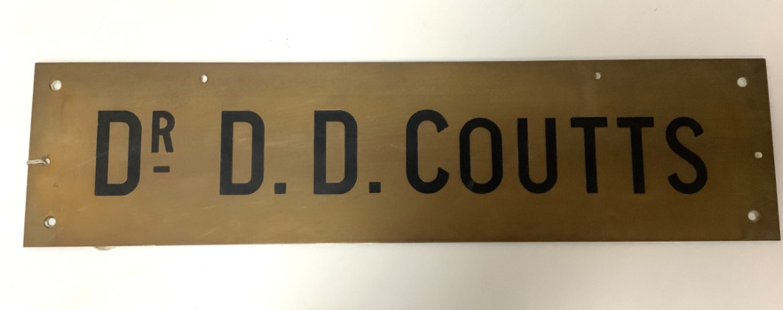 Rextangular brass plaque inscribed “Dr D.D. Coutts”