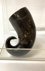Section of curved, polished dark brown animal horn, probably from a goat or a sheep, used as a snuff container.
