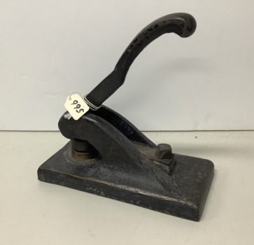 Heavy cast iron implement with spring loaded lever, which when depressed brings two dies together to make an impression on paper. The press is painted with black enamel paint and  gold ‘coach-work’ filligree. 