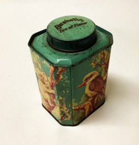 A Bushells eight-sided cylindrical tin tea caddy with a lid. Four sides are large, the other four are small. It is decorated with polychrome transfers in blue, green, yellow and grey, depicting Australian animals in  bushland setting. On the larger sides: a kangaroo, a koala, a kookaburra and an emu. 