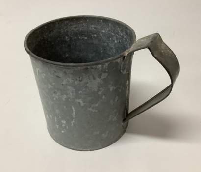 Small galvanized iron dipper with soldered handle, mainly for transferring water.