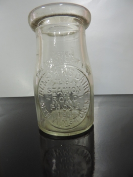 Small clear glass bottle for cream, embossed front and back, from Dunstans dairy Williamstown