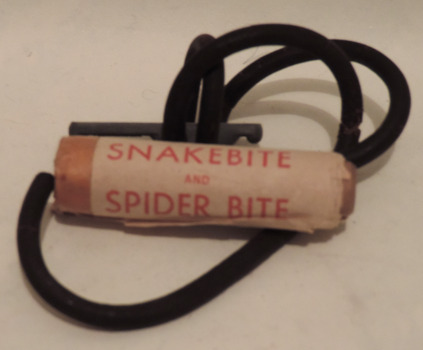 Sanax snake and spider bite kit, comprising:
1. Metal and rubber tourniquet 
2. Lancet in wooden case
3. Small sheet describing treatment for a snake or spider bite