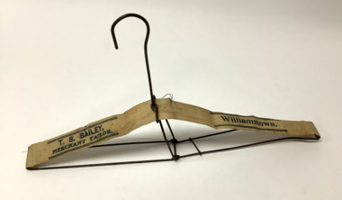 Folding wire clothes hanger, with canvas webbing strip from Baileys clothing store in Willaimstown