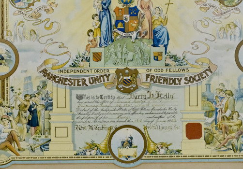 Framed ornate and hand coloured certificate presented to Grand Master Barry Kelly, from the Manchester Unity Friendly Society, 1932.