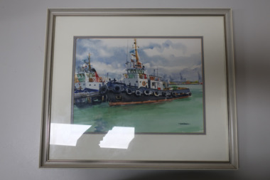 Coloured watercolour painting of two tug boats docked at Williamstown. The tug in the foreground is the "Latrobe". Dock cranes at Port Melbourne in background. Framed in a gold painted wooden frame, on a white mat. Painted by Jean Harris.