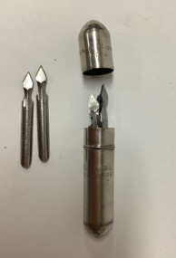 Small bullet-shaped steel container with a lid, holding 18 arrow-shaped, disposable steel styles used for vaccination against smallpox