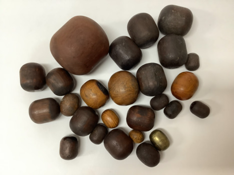 Plumber's bobbins - 25 wooden bobbins of various sizes, and one small brass bobbin which has hole through the middle and screws open into two halves. Wood for the bobbins was often chosen for its hardness. 