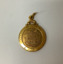 Small 9 carat gold round gold medallion with ring for attaching to a chain or fob. Coat of arms of Williamstown on the face.  Obverse engraved. Commemorating Councillor R A E Ducrow, Mayor of Williamstown from 1948 to 1960. In original cream coloured plastic, square lidded box with burgundy velvet lining.