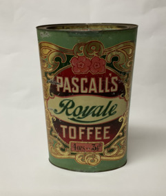 A large oval lidded tin that has been highly decorated with a gold filigree border, and a large scrolled product name. Main colours are red, pink, green and gold. The price for toffees is shown as 4oz for 3 1/2 d.