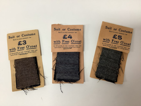 Front view of three Myerson suit or costume fabric samplers: small fabric samples stapled to a cardboard card. 