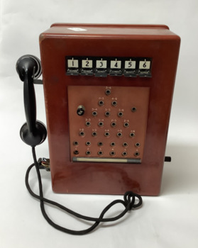 Six-line telephone exchange unit in wooden casing.