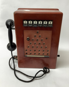 Six-line telephone exchange unit in wooden casing.
