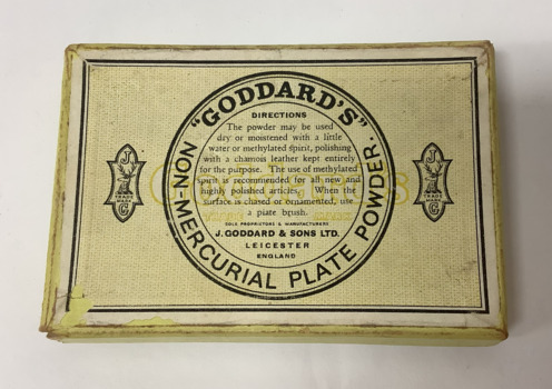 Small oblong lidded box (empty) which contained non-mercurial plate powder manufactured by J. Goddard & Sons, Leicester, England. The box has a yellow coloured background, the manufacturer's details and trade mark, and directions for use. The powder was used in silver polishing.