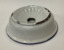 White enamel soap dish with a blue rim around the base of the bowl - an enamel insert with a large hole holds the soap and drains water into the dish. 