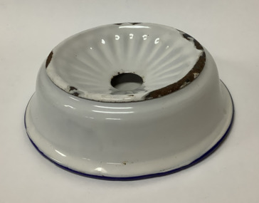 White enamel soap dish with a blue rim around the base of the bowl - an enamel insert with a large hole holds the soap and drains water into the dish. 