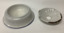 White enamel soap dish with a blue rim around the base of the bowl - an enamel insert with a large hole holds the soap and drains water into the dish. 