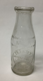 Clear glass small milk bottle with embossed inscription, from F.G. Smith's Jersey Dairy Mason St.  NEWPORT