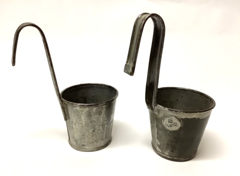 Two tin ladles or dippers, with long hooked handles. One has an Imperial measurement stamp.