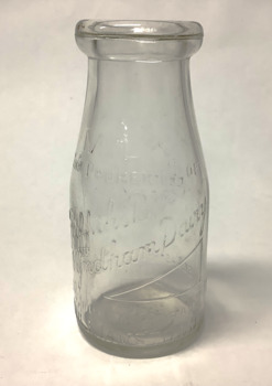Clear glass milk bottle, 10 ozs. (283.5 grams) capacity,  with embossed information, from Griffiths dairy Williamstown.