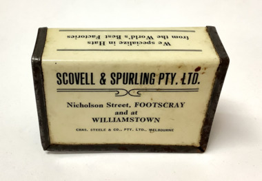 Metal matchbox or Vesta cover with black type on white background, covered in clear plastic. From Scovell and Spurling menswear stores in Footscray and Williamstown.
