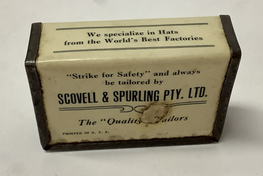 Metal matchbox or Vesta cover with black type on white background, covered in clear plastic. From Scovell and Spurling menswear stores in Footscray and Williamstown.