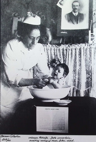 Photograph - Unknown nurse weighing a child, c.1920-30's