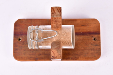 Glass jar and wood stand with a collection of sand from the WW1 Battlefield at Beersheba.  Titled "The Sands of Beersheba", Collected in 2008