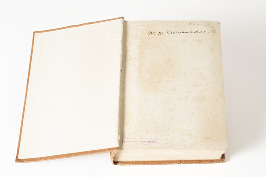 This is a small sized book in a solid orange colour hardback. There is text in gold on the front and spine that reads: Wilfred C. Busse / The Golden Plague / 