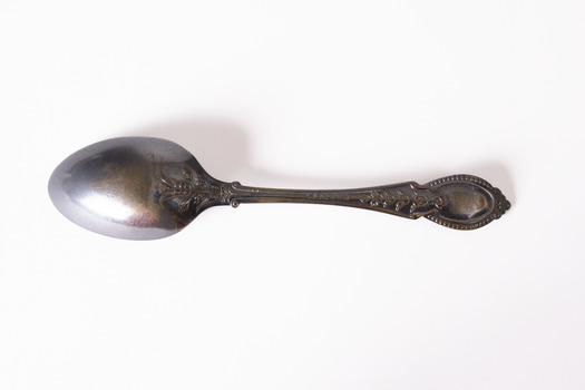Rear view of teaspoon with tarnished patina. 