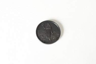 Back side of a small, round, dark-coloured medal. Inscribed on the medal is: The Royal Agricultural Society of Victoria / Busse & Son / 1895