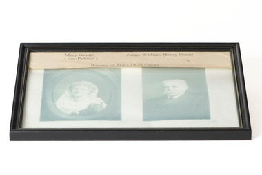 Two portrait black and white photographs, female on the left and male on the right, in a single black frame with basic relief. Paper overlay in top of frame with text that reads "Mary Gaunt (nee Palmer), Judge William Henry Gaunt, Parents of Mary Eliza Gaunt"