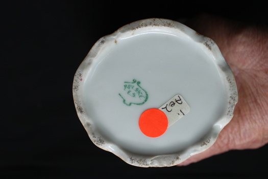 Round base of vase with scalloped rim and  green trade mark ROW SXE E.S. in a spade like shape 