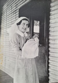 Photograph, Sister Bertram and baby, Copy 1989 original 1942