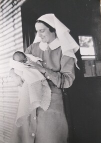 Photograph - copy, Sister Moore and Japanese baby, Original 1942 copy 1989