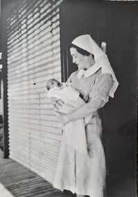 Photograph, Sister J Bertram nursing baby, Original 1942, copy 1989