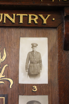 Wooden Honour Board containing fifteen names listed in the centre surrounded by 11 numbered photographs.