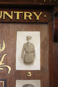 Wooden Honour Board containing fifteen names listed in the centre surrounded by 11 numbered photographs.
