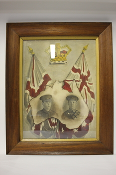 Timber frame containing image of two soldiers within a map of Australia below a crown and two flags.
