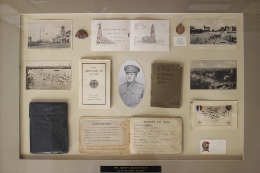 Framed Collection of personal effects Including photographs and badges