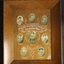 Brown timber frame and mount containing eight photographs of soldiers.
