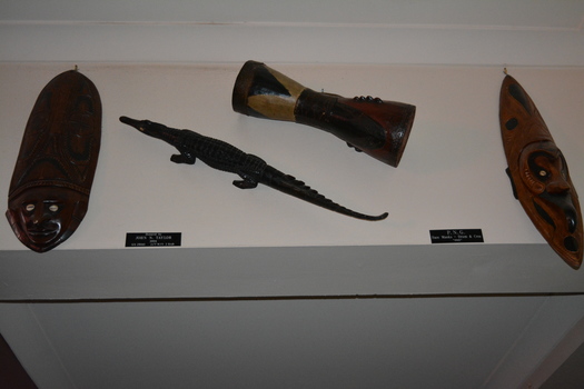 Two decorative wooden face masks, one wooden Drum and one wooden Crocodile
