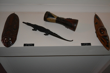 Two decorative wooden face masks, one wooden Drum and one wooden Crocodile