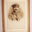 Gold coloured metal frame  containing sepia photograph of Army Officer with moustache