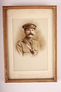 Gold coloured metal frame  containing sepia photograph of Army Officer with moustache