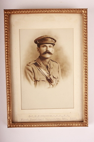 Gold coloured metal frame  containing sepia photograph of Army Officer with moustache