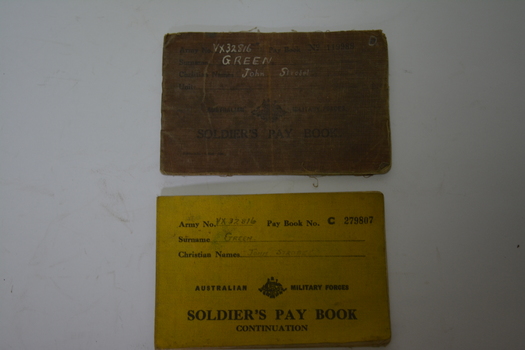Brown cloth covered booklet with black writing and crest in the middle of the cover.