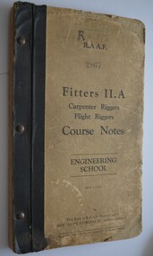 Book has black binding with metal studs.  Cover is  off-white with black writing.