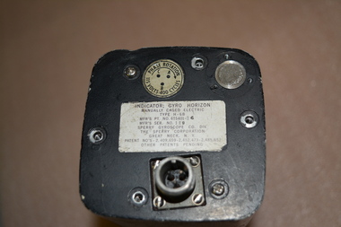Aircraft Gyro Horizon Indicator - silver metal instrument comprising of multiple parts housed in black metal oblong unit.